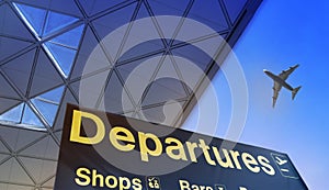 Departure sign and airplane in the sky