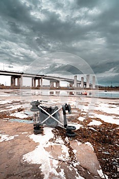 depiction of dereliction and emptiness child\'s pram lying on its side in a expanse of urban wasteland photo