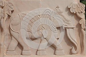 Depiction of elephants on red stone by carving