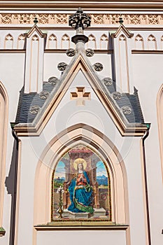 Depiction of Virgin Mary with a book on the outside of St. Nikolaus church, Rosenheim, Germany