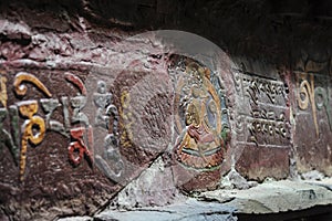 Depictions of Buddha on stone outside the Mindroling Monastery - Zhanang County, Shannan Prefecture, Tibet Autonomous Region/China photo