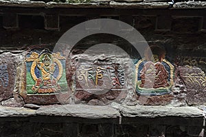 Depictions of Buddha on stone outside the Mindroling Monastery - Zhanang County, Shannan Prefecture, Tibet Autonomous Region/China