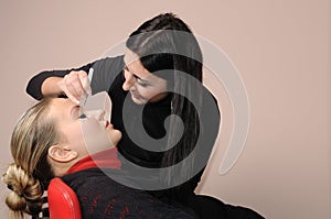 Depilating a woman's eyebrows