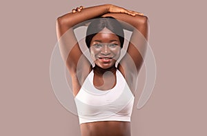 Depilation Concept. Happy African American Woman Showing Her Smooth Armpits