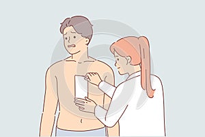 Depilation hair on chest of man, experiencing pain from tearing wax tape, stands near cosmetologist