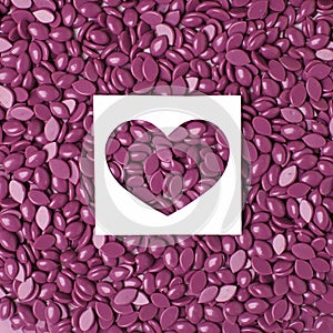 Depilatory Pearl Hard Wax Beans purple color and heart, concept of skincare bodycare, beauty industry, spa salon, hait remove
