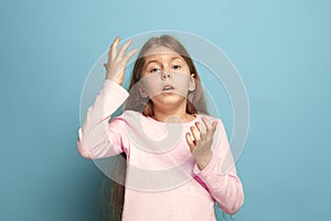 The deplorable girl. Teen girl on a blue background. Facial expressions and people emotions concept photo