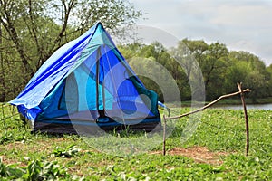 Deployed tent stands on river bank