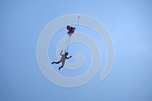 The deployment of a parachute in the sky.