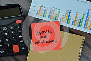 Deposits and Withdrawals write on sticky notes isolated on Wooden Table