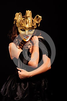 Depraved woman in golden half mask
