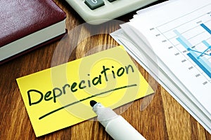 Depreciation concept. Stack of business papers photo