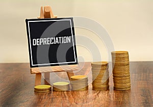 Depreciation Sign with currency gold coins stack photo