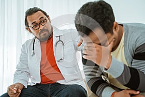 Depress patient consulting with his doctor in his office