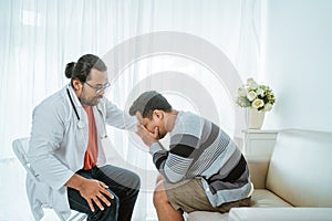 Depress patient consulting with his doctor in his office