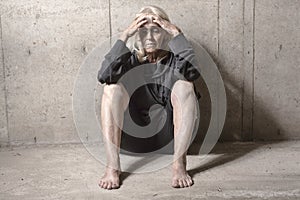 Depress senior person with concrete background