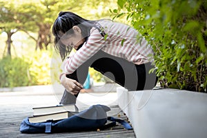 Depressed asian child girl student failed important test,female student sit hugs her knees up to the chest and crying alone,sad