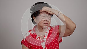 Depressed Asian senior woman lonely disappointed and lose memory in isolated white background. Portrait old woman ill sick