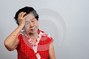 Depressed Asian senior woman lonely disappointed and lose memory in isolated white background. Portrait old woman ill sick