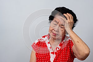 Depressed Asian senior woman lonely disappointed and lose memory in isolated white background. Portrait old woman ill sick