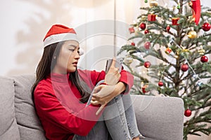 Depressed Asian Woman Spend Her Christmas Time Alone at Home Watching on Her Mobilephone Screen
