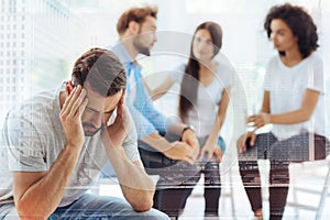 Depressed bearded man attending psychologist