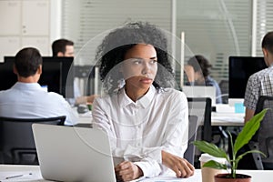 Depressed black woman distracted from work lost in thoughts photo