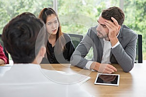 Depressed boss during a meeting in office . businessman stressed holding hands on head Serious