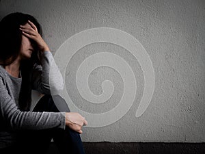 Depressed broken hearted woman sitting alone in dark room