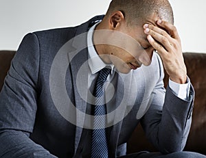 Depressed business man sitting on a couch