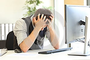 Depressed businessman after bankruptcy at office photo