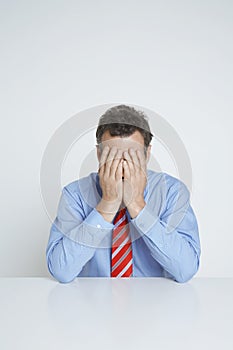 Depressed Businessman Covering Face