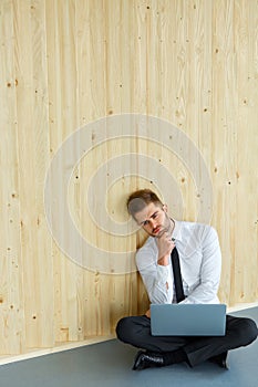 Depressed Businessman sitting on floor at his office. Hard work