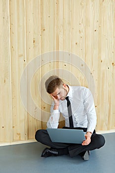 Depressed Businessman sitting on floor at his office. Hard work