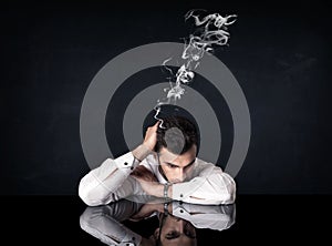 Depressed businessman with smoking head