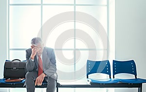 Depressed businessman in the waiting room