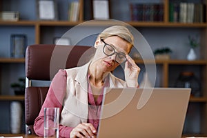 Depressed businesswoman overworked on laptop computer. Tired worker recieved bad online news. Financial crisis