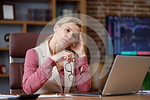Depressed businesswoman overworked on laptop computer. Tired worker recieved bad online news. Financial crisis
