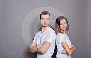 Depressed couple after quarrel on a gray background