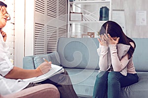 Depressed crushed downhearted brown-haired client having a therapy with psychologist. photo