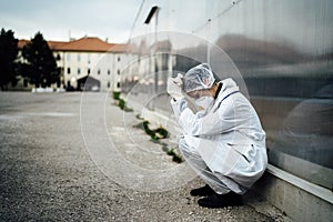 Depressed crying doctor with mask having mental breakdown.Fear,anxiety,panic attack due to coronavirus outbreak.Psychological