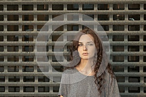 Depressed Girl In front Of metal Mesh. Teenager Prisoner