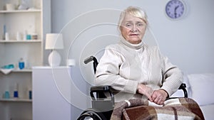 Depressed grandmother in wheelchair looking camera, pension sickness, health