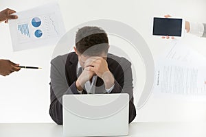 Depressed male employee tired by excessive workload and clients