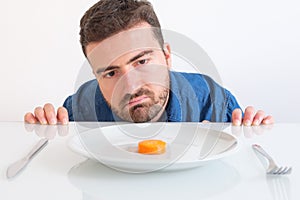 Depressed man dieting and eating only vegetables