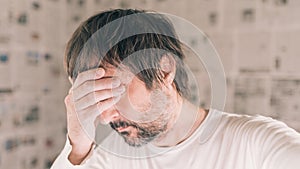 Depressed man in infodemic concept photo