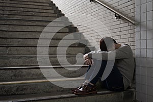 Depressed man sit in underground