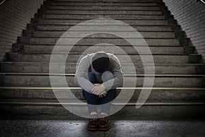 Depressed man sit in underground