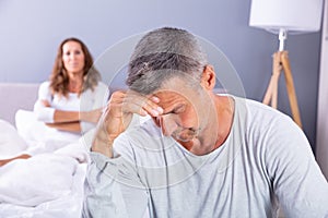 Depressed Man Sitting On Bed photo
