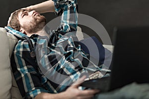 Depressed man sitting on the couch